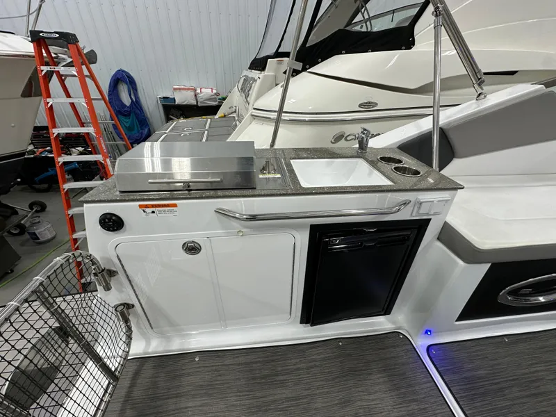 Slide: The Image of 2021 Four Winns Vista 275 boat with outdoor kitchenette and seating area. - 5