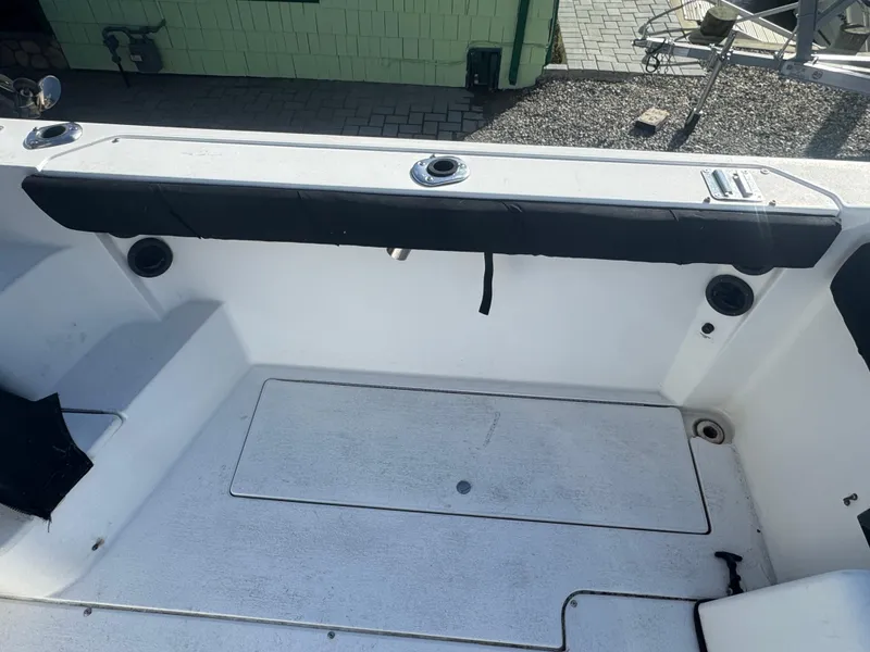 Slide: The Image of 2004 Seaswirl Striper 2601 Walkaround I/O cabin interior with sink and wooden seat. - 10