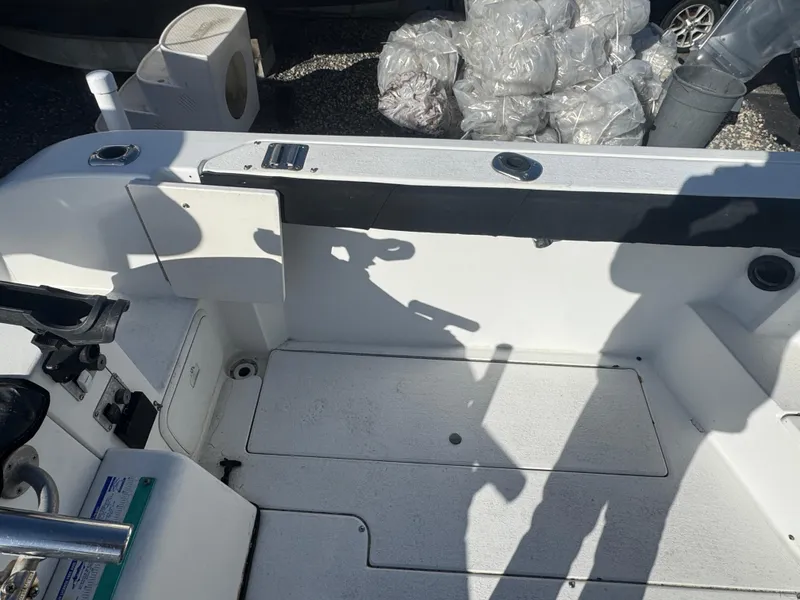 Slide: The Image of 2004 Seaswirl Striper 2601 Walkaround I/O cabin interior with cushioned seating and storage. - 11