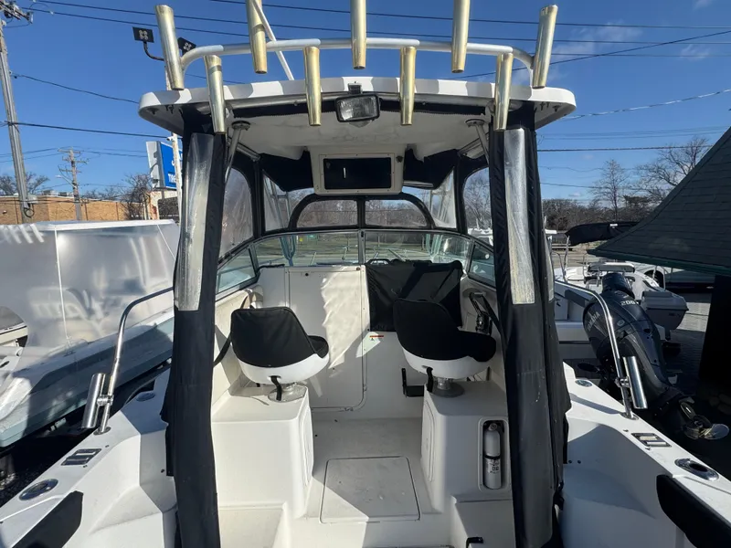 Slide: The Image of 2004 Seaswirl Striper 2601 Walkaround I/O boat interior with seating and helm. - 12