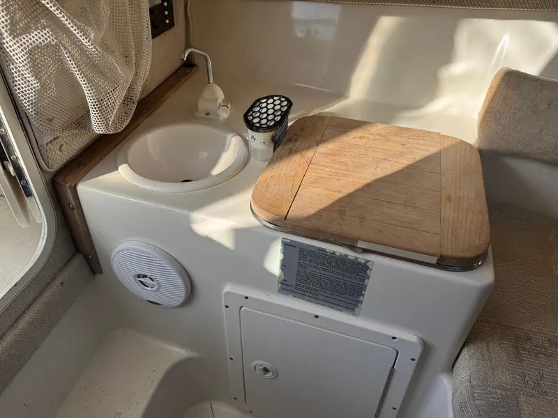 Slide: The Image of 2004 Seaswirl Striper 2601 Walkaround I/O boat deck with fishing rod holders. - 3