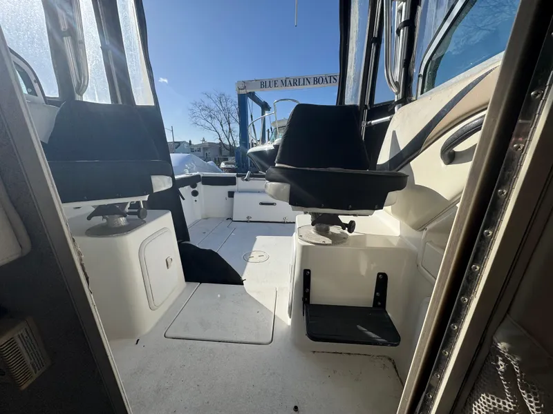 Slide: The Image of 2004 Seaswirl Striper 2601 Walkaround I/O boat interior with fishing rod holders. - 8