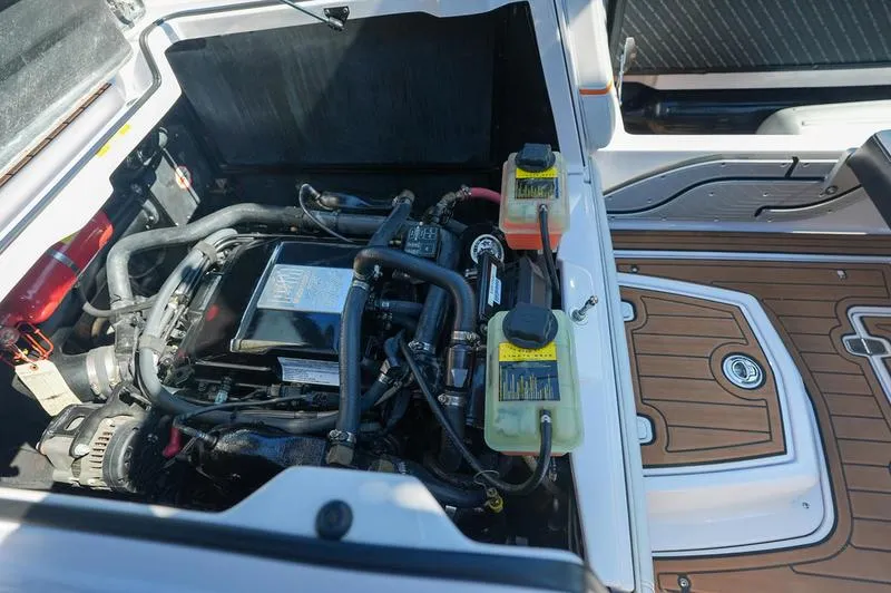 Slide: The Image of Engine compartment of a 2015 Nautique Super Air G23 boat, showcasing detailed components. - 15