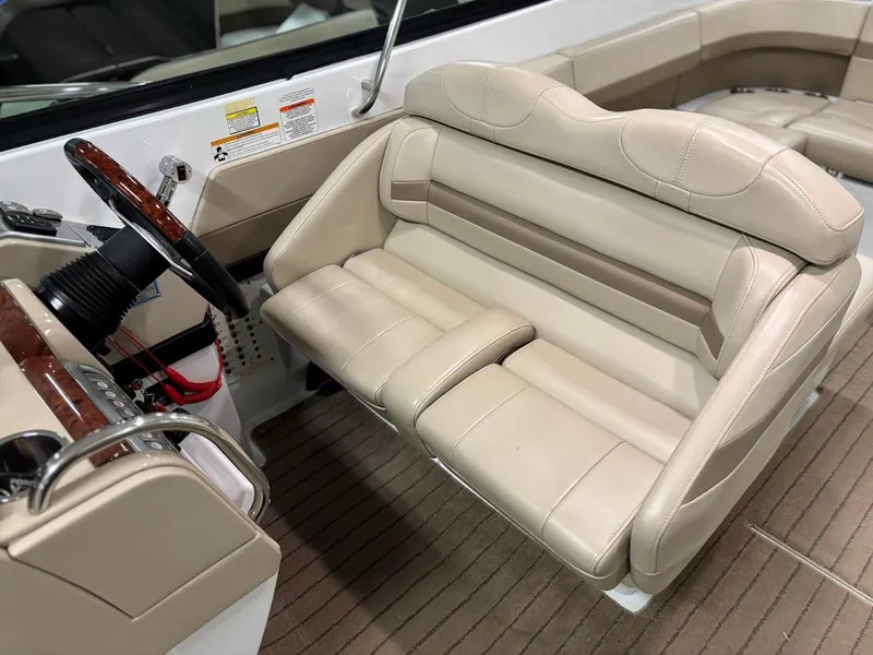 Slide: The Image of 2012 Formula 290 Bowrider interior with beige seating and steering wheel. - 12