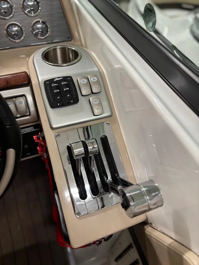 Slide: The Image of Control panel of a 2012 Formula 290 Bowrider boat with throttle levers and switches. - 16