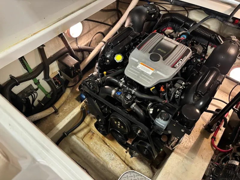 Slide: The Image of Engine compartment of a 2012 Formula 290 Bowrider boat, showcasing detailed mechanical components. - 18