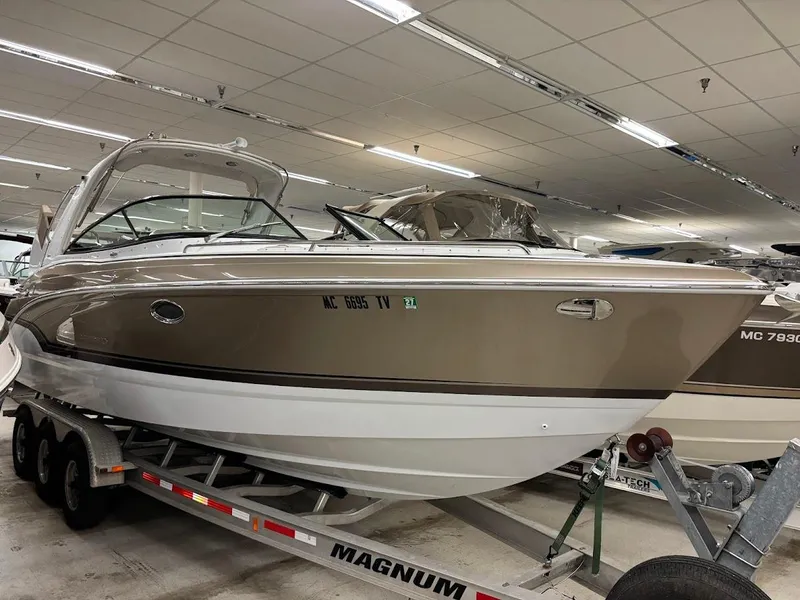Slide: The Image of 2012 Formula 290 Bowrider boat on trailer in indoor showroom. - 2