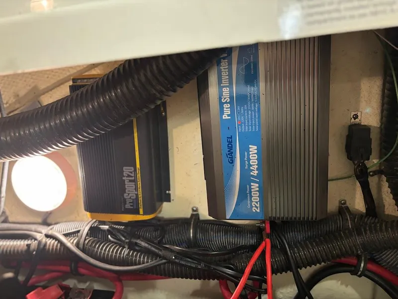 Slide: The Image of Electrical components inside a 2012 Formula 290 Bowrider boat, featuring inverters and wiring. - 20