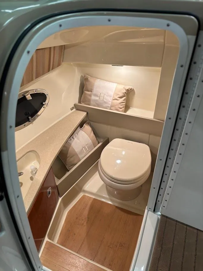 Slide: The Image of 2012 Formula 290 Bowrider interior bathroom with modern amenities and wooden flooring. - 22