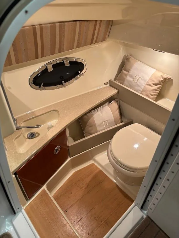 Slide: The Image of 2012 Formula 290 Bowrider bathroom with sink, toilet, and wooden flooring. - 23
