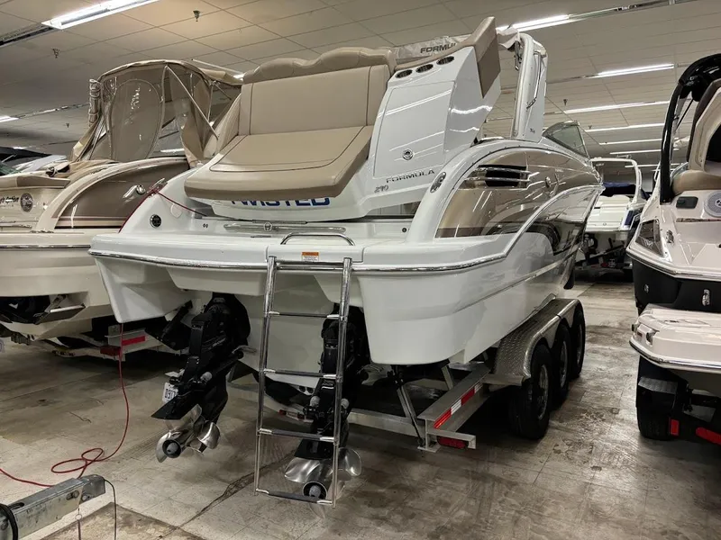 Slide: The Image of 2012 Formula 290 Bowrider boat on trailer in showroom, rear view. - 3