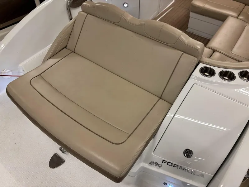 Slide: The Image of 2012 Formula 290 Bowrider boat interior with beige seating and cup holders. - 5