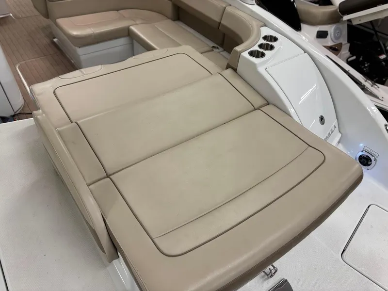 Slide: The Image of 2012 Formula 290 Bowrider boat interior with beige seating and cup holders. - 7