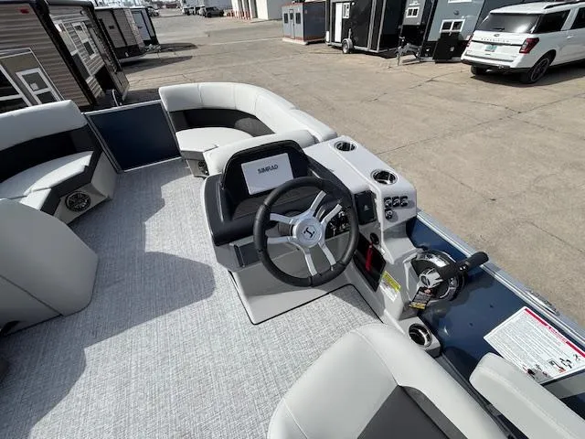Slide: The Image of 2025 Harris Cruiser 210 SLDH pontoon boat interior with steering wheel and seating. - 10