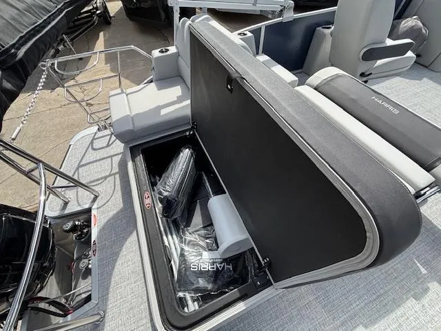Slide: The Image of 2025 Harris Cruiser 210 SLDH boat with open storage compartment and seating area. - 15