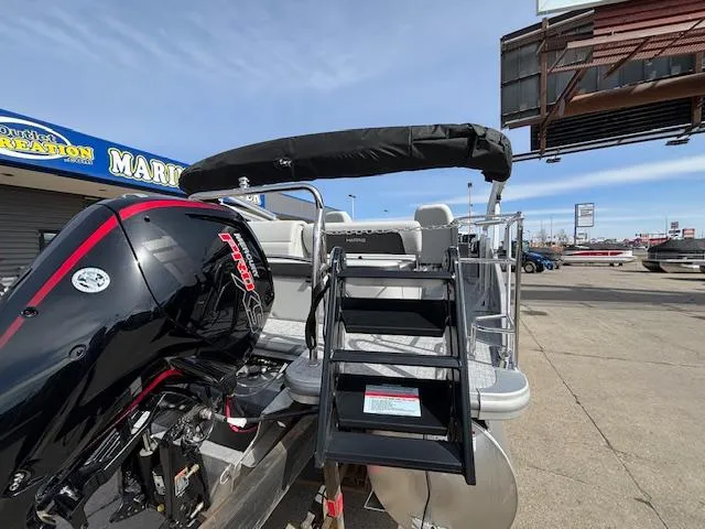 Slide: The Image of 2025 Harris Cruiser 210 SLDH pontoon boat with outboard motor and boarding ladder. - 27