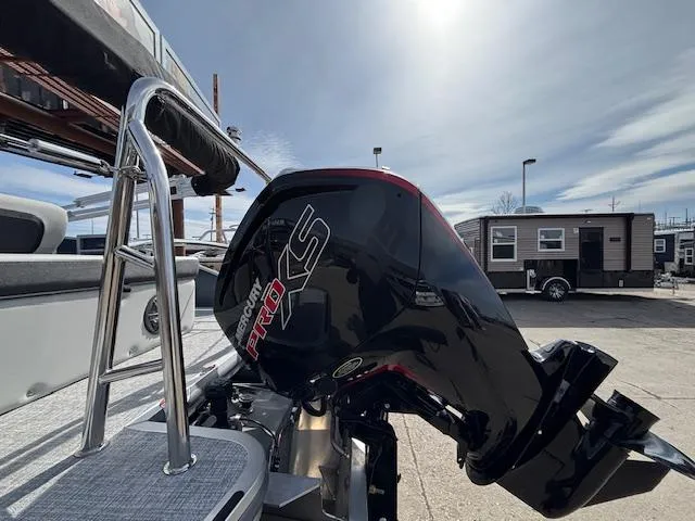 Slide: The Image of 2025 Harris Cruiser 210 SLDH with Mercury Pro XS outboard motor in a sunny outdoor setting. - 28