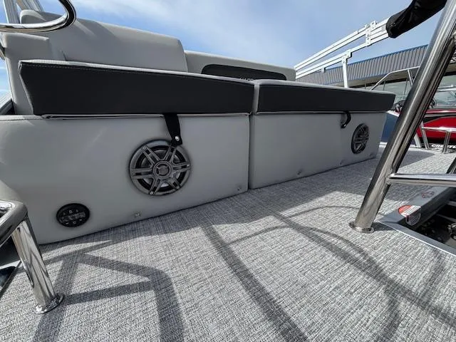 Slide: The Image of 2025 Harris Cruiser 210 SLDH boat interior with speakers and seating on a textured deck. - 3
