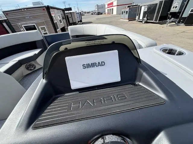 Slide: The Image of 2025 Harris Cruiser 210 SLDH dashboard with Simrad display, outdoor setting. - 8