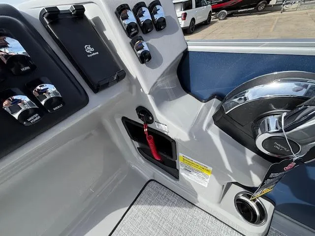 Slide: The Image of Control panel of 2025 Harris Cruiser 210 SLDH boat with steering wheel and switches. - 9