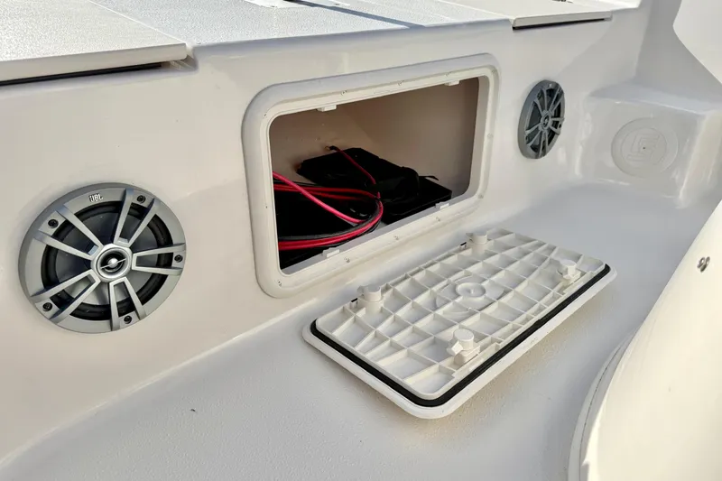 Slide: The Image of 2025 Carolina Skiff 19 LS boat storage compartment with speakers and wiring. - 10