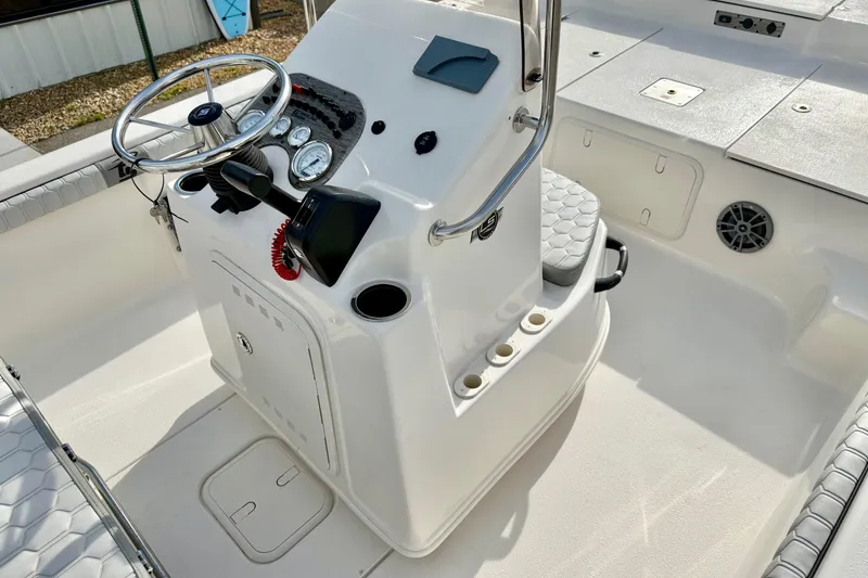 Slide: The Image of 2025 Carolina Skiff 19 LS boat console with steering wheel and controls. - 17