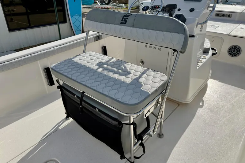 Slide: The Image of 2025 Carolina Skiff 19 LS boat interior with cushioned seating and storage. - 22