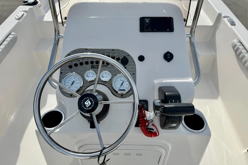 Slide: The Image of 2025 Carolina Skiff 19 LS boat dashboard with steering wheel and control panel. - 3