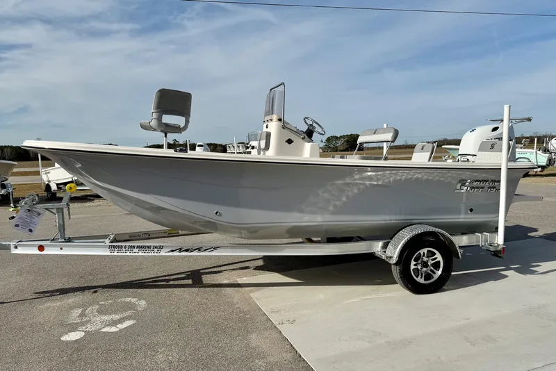 Slide: The Image of 2025 Carolina Skiff 19 LS boat on trailer, parked outdoors under clear sky. - 5