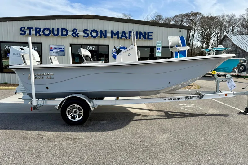 Slide: The Image of 2025 Carolina Skiff 19 LS boat on trailer at Stroud & Son Marine dealership. - 6