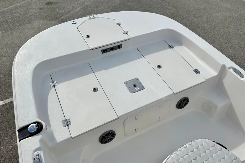 Slide: The Image of 2025 Carolina Skiff 19 LS boat deck with storage compartments and speakers. - 8