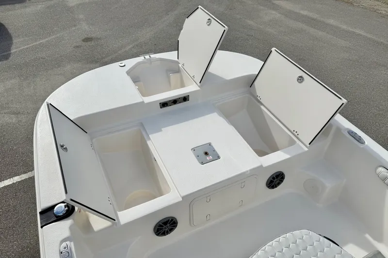 Slide: The Image of 2025 Carolina Skiff 19 LS boat interior with open storage compartments and seating area. - 9
