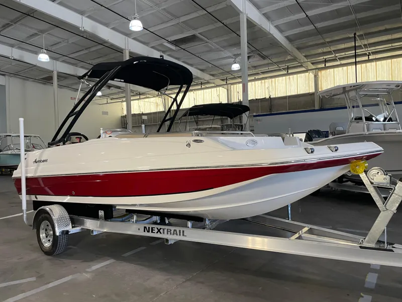 Slide: The Image of 2021 Hurricane SunDeck Sport 201 OB boat on trailer in indoor showroom. - 0
