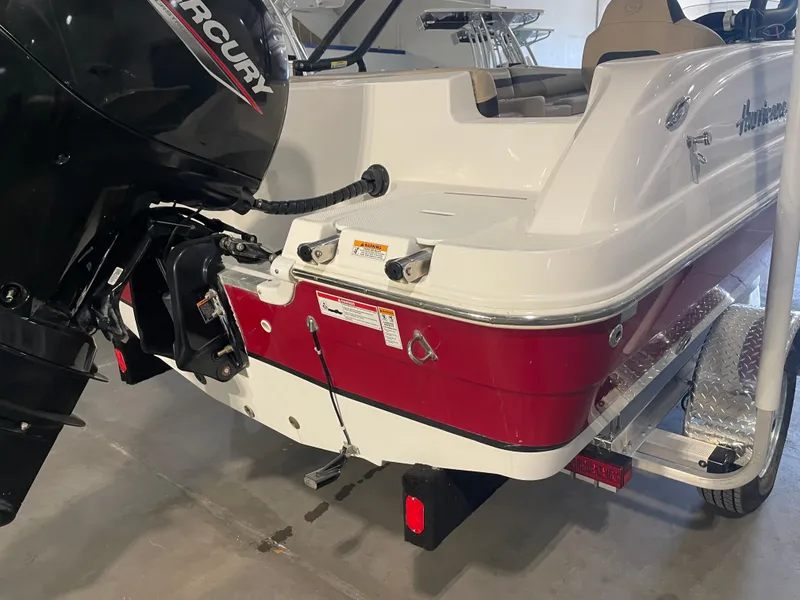 Slide: The Image of 2021 Hurricane SunDeck Sport 201 OB boat with Mercury outboard motor, red and white design. - 11