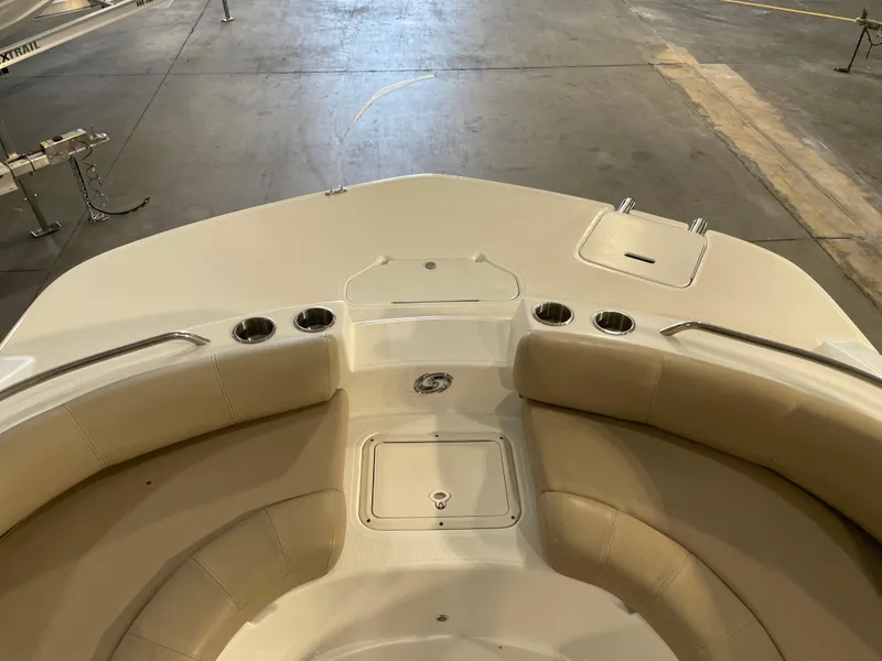 Slide: The Image of 2021 Hurricane SunDeck Sport 201 OB boat interior with cushioned seating and cup holders. - 16