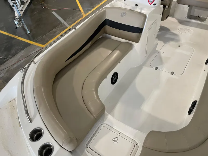 Slide: The Image of 2021 Hurricane SunDeck Sport 201 OB boat interior with beige seating and storage compartments. - 18