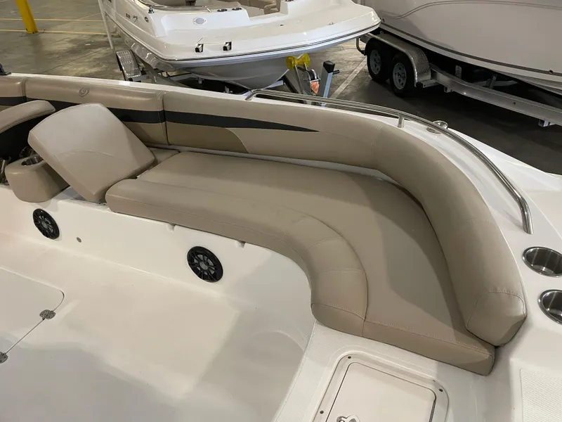 Slide: The Image of 2021 Hurricane SunDeck Sport 201 OB boat interior with beige seating and cup holders. - 19