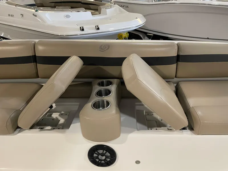 Slide: The Image of 2021 Hurricane SunDeck Sport 201 OB boat interior with beige seating and cup holders. - 20