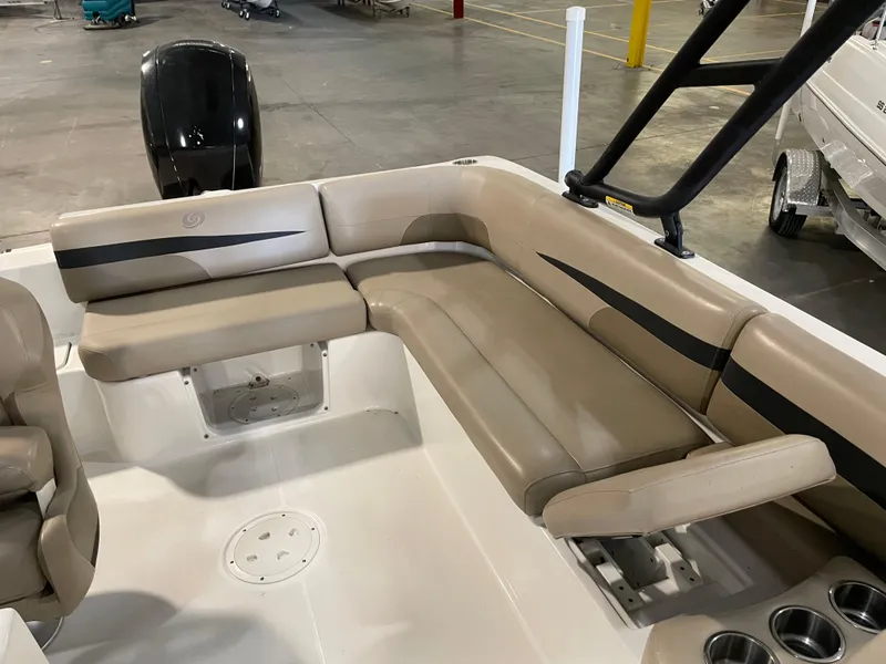Slide: The Image of 2021 Hurricane SunDeck Sport 201 OB boat interior with beige seating and cup holders. - 21