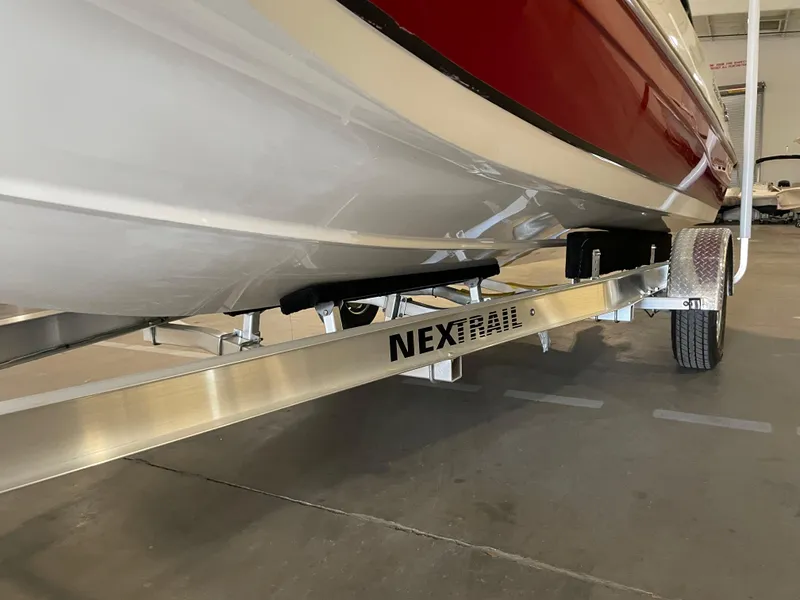 Slide: The Image of 2021 Hurricane SunDeck Sport 201 OB on NexTrail trailer in a garage. - 31