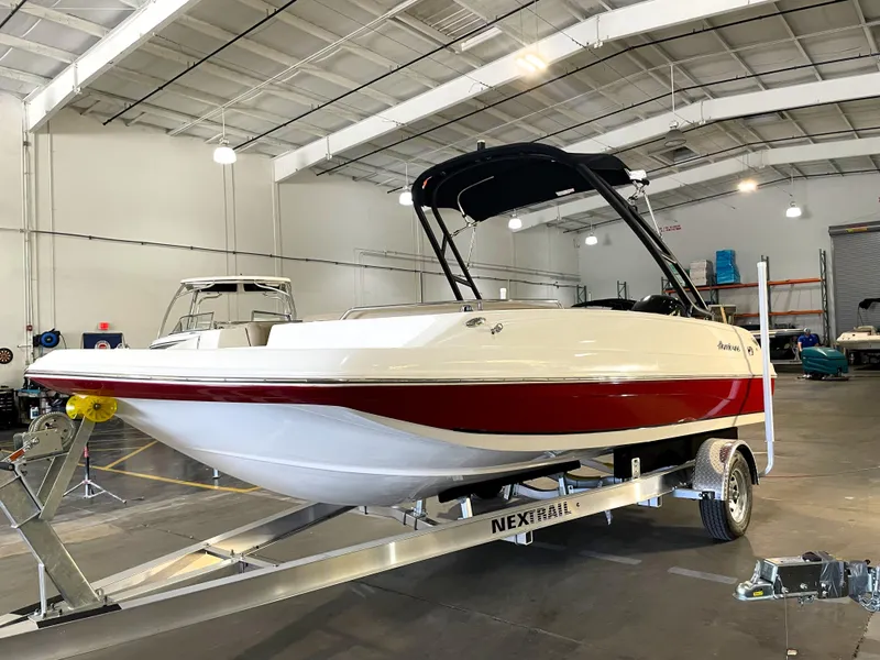 Slide: The Image of 2021 Hurricane SunDeck Sport 201 OB boat on trailer in indoor showroom. - 4