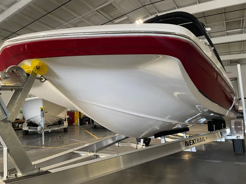 Slide: The Image of 2021 Hurricane SunDeck Sport 201 OB boat on trailer in indoor showroom. - 8