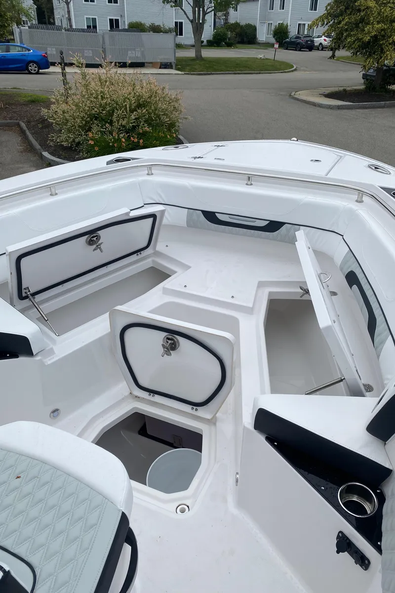 Slide: The Image of 2025 Blackfin 252 CC boat interior with open storage compartments and seating. - 12