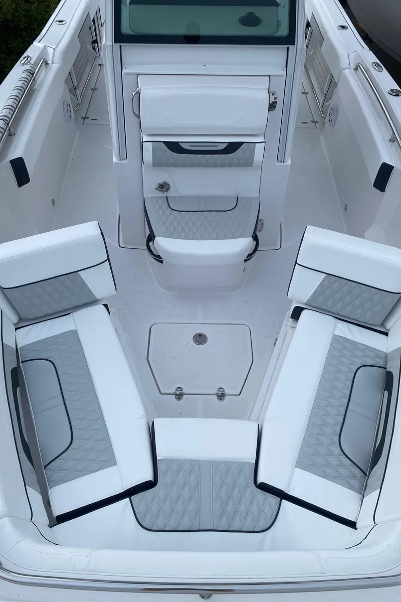 Slide: The Image of 2025 Blackfin 252 CC boat interior with white and gray seating arrangement. - 14