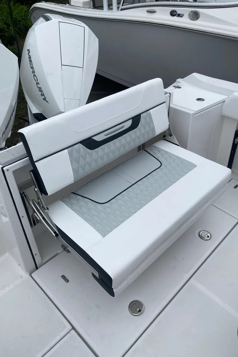 Slide: The Image of 2025 Blackfin 252 CC boat with white seating and Mercury engine. - 6