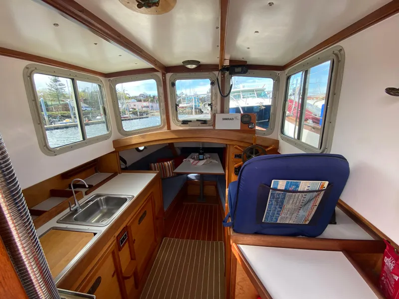 Slide: The Image of Interior of 1992 Devlin Surf Scoter boat with kitchen and seating area. - 12