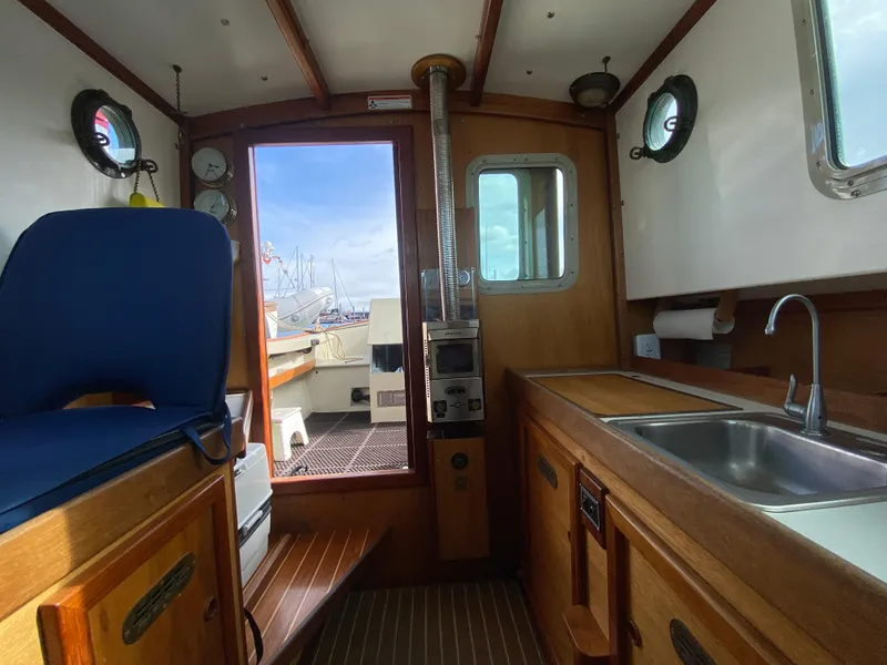 Slide: The Image of Interior of 1992 Devlin Surf Scoter boat with wooden cabinetry and nautical decor. - 18