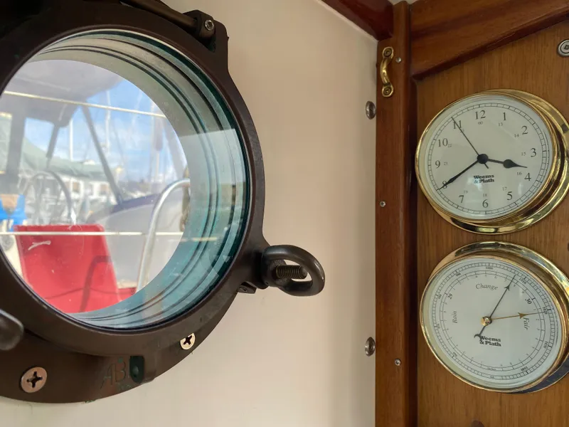 Slide: The Image of Porthole and gauges inside a 1992 Devlin Surf Scoter boat cabin. - 19