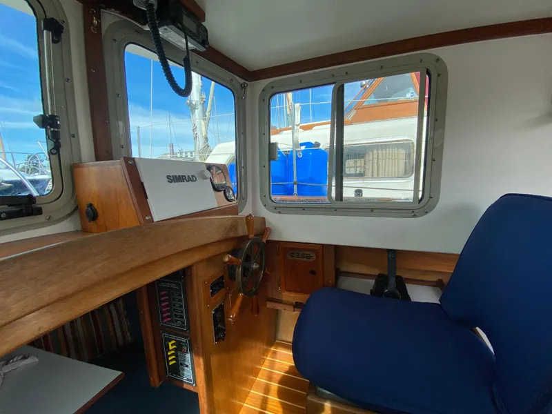 Slide: The Image of Interior of 1992 Devlin Surf Scoter boat with wooden dashboard and blue seating. - 8