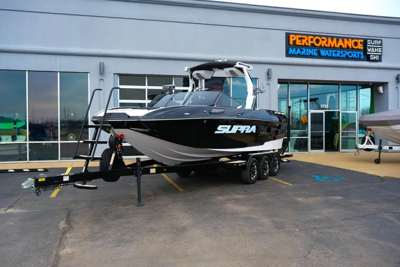 The Image of 2025 Supra SE450 boat on trailer at Performance Marine Watersports dealership. - 1